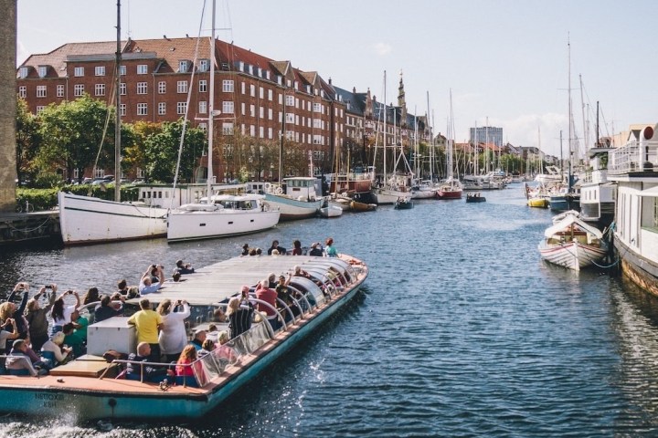 a group of people in a small boat in a body of water