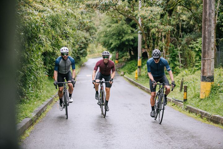 a group of people riding on the back of a bicycle